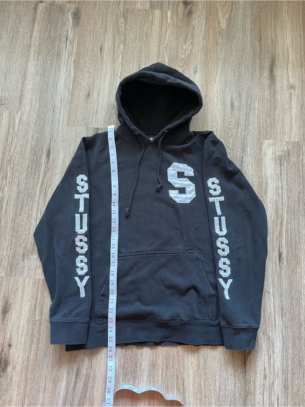 Vintage 2000s black Stüssy hoodie with white collegiate lettering. Size medium